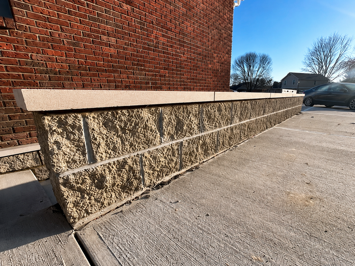 Split-face masonry wall with cap detail